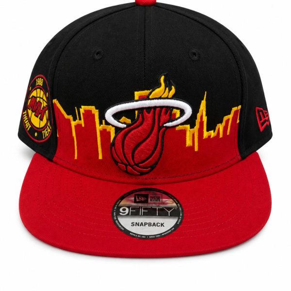 Black and red Miami Heat snapback cap with city skyline and flaming basketball logo on the front panel, brim red, side patch visible.