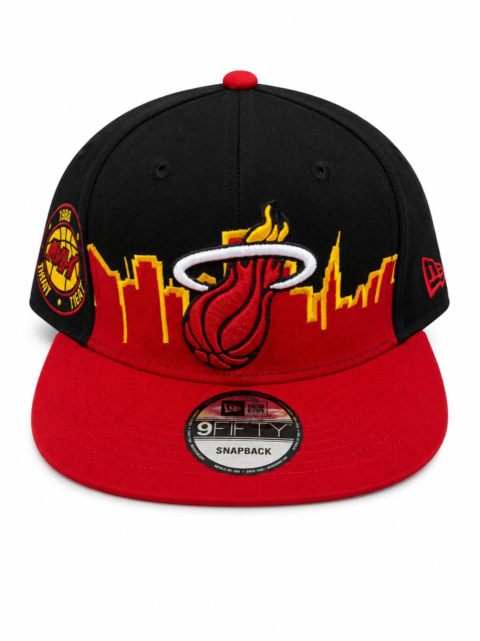 d6b7b029-6b45-468c-b4db-cf06cd3e064d Black and red Miami Heat snapback cap with city skyline and flaming basketball logo on the front panel, brim red, side patch visible.