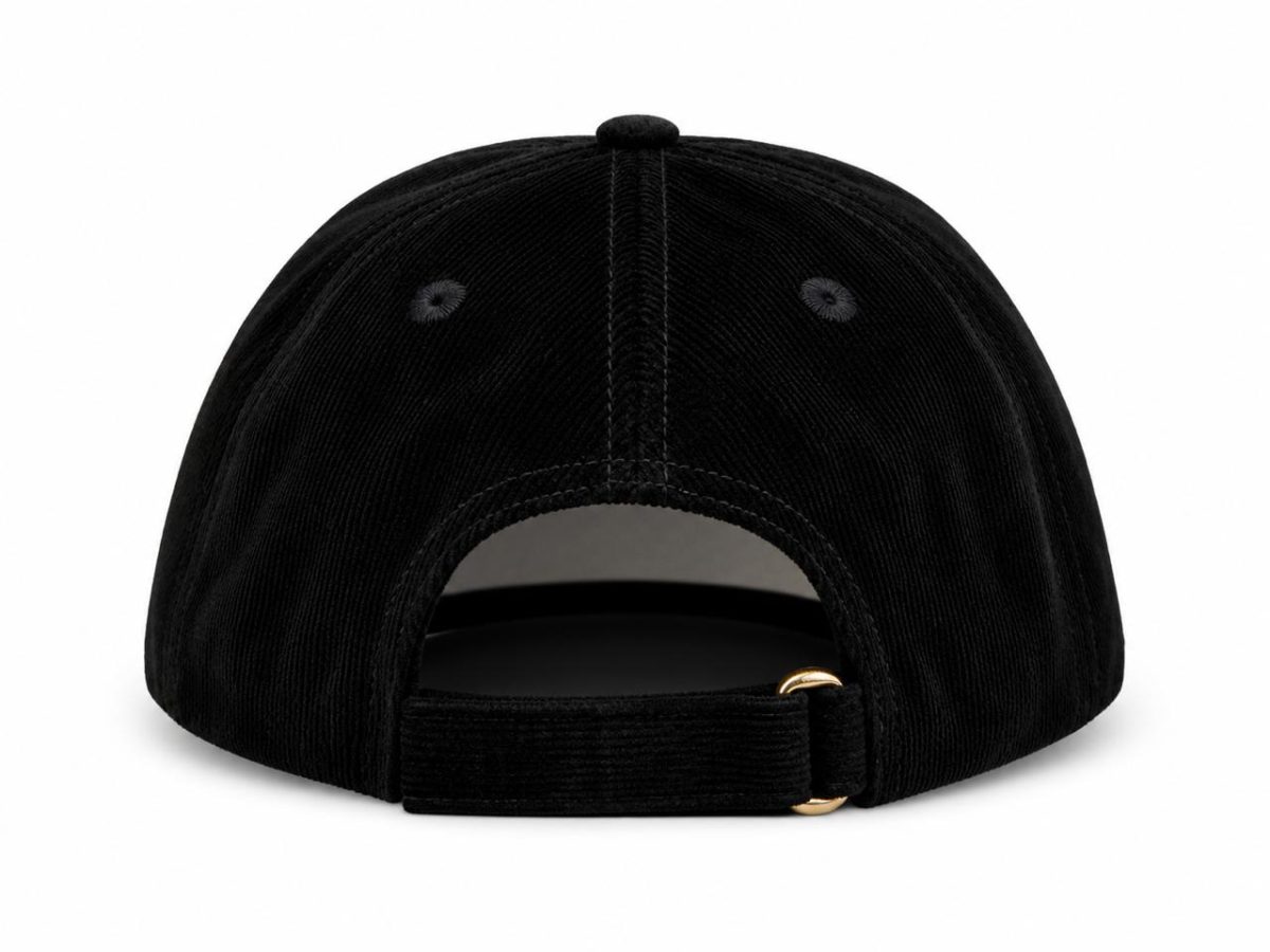 Back view of a black corduroy baseball cap with an adjustable strap and brass buckle detail.