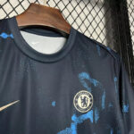 Navy Chelsea FC football jersey on hanger, featuring the club crest and a gold Nike swoosh on the left chest area.