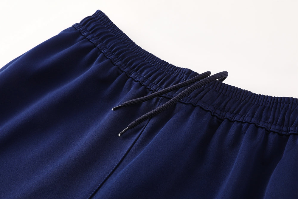 d740b511 | UAE SPORT STORE Close-up of a navy blue elastic waistband with a black drawstring on athletic shorts/pants.