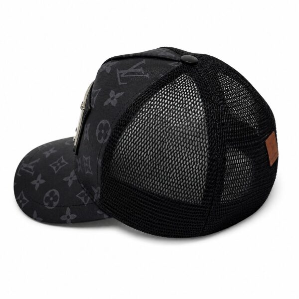 Black trucker cap with a dark Louis Vuitton monogram print on the front and black mesh back panels, with a metal button on top.