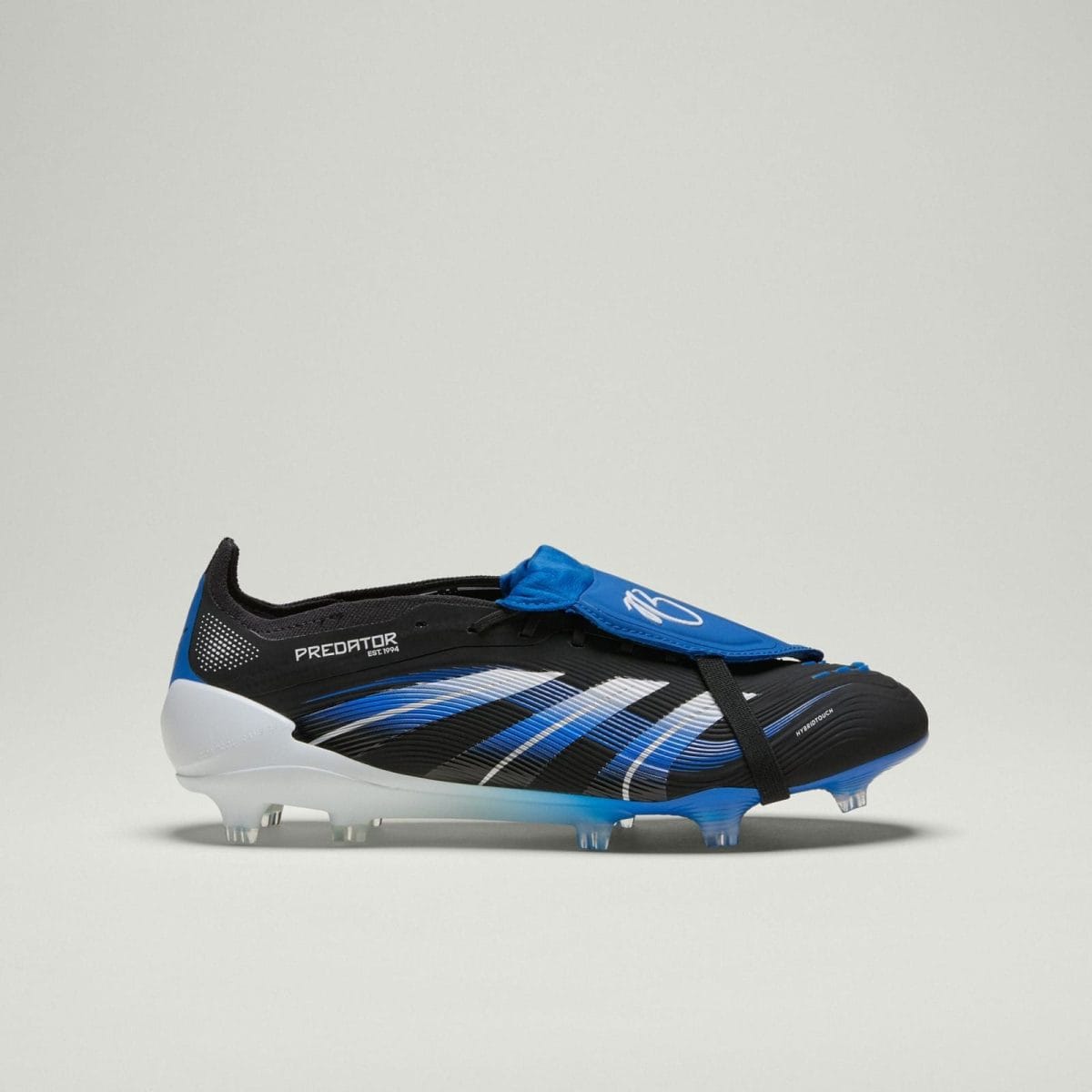 Black and blue Adidas Predator football boot with white stripes, shown from side on a light background.