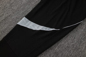 Black athletic pants with a light gray reflective panel across the thigh area