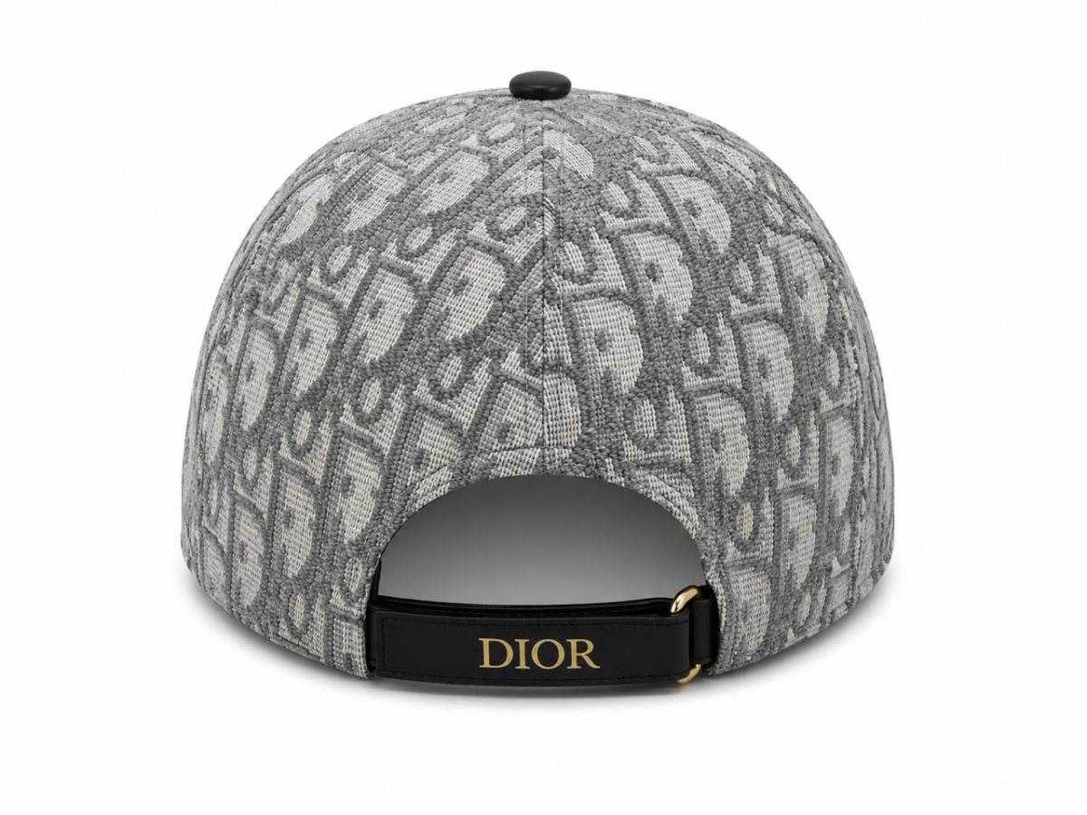 Back view of a grey textured cap with a black strap and gold buckle featuring the Dior logo