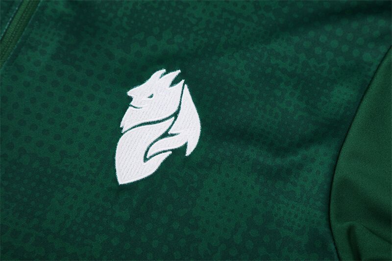 da43703d-19e9-4a79-8f24-ed9ac56ad999 | UAE SPORT STORE White stylized animal logo (dragon/phoenix) on dark green athletic fabric with subtle dotted pattern.