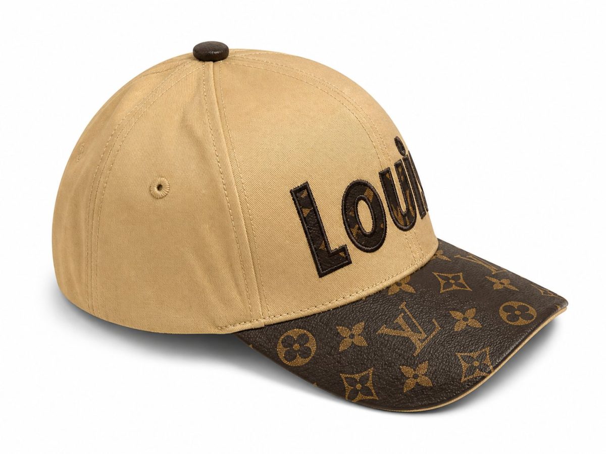 Beige baseball cap with a dark brown LV-patterned brim and bold black embroidered letters on the front.