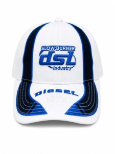 White cap with blue piping and embroidered 'SLOWBURNER' logo on the front and 'Diesel since 1978' text on the brim.