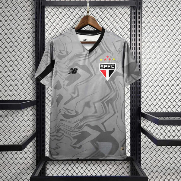Gray camouflage-pattern SPFC football jersey on a wooden hanger in a display rack.