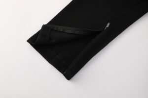 Black athletic pants leg with a small zippered pocket along the seam on the side
