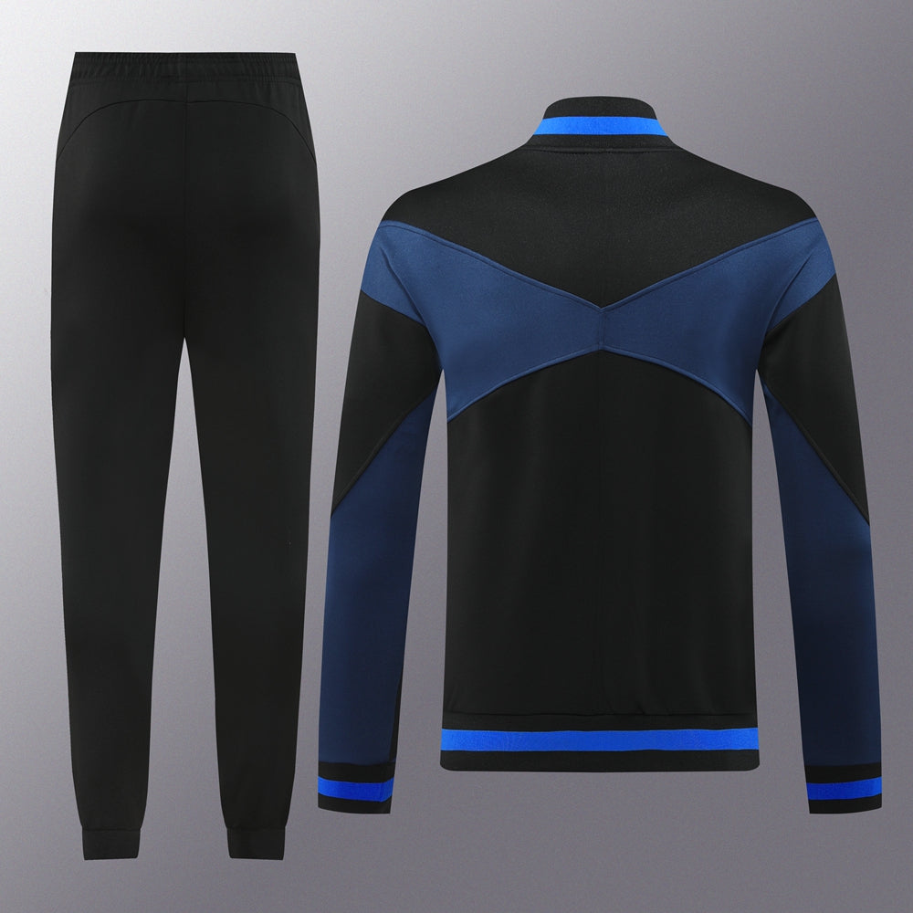 de99d03f | UAE SPORT STORE Black track pants with elastic waistband and cuffs paired with a color-blocked blue and black jacket featuring chevron panels and blue trim at the hem and cuffs
