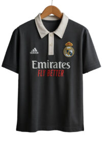 Black Real Madrid polo shirt on a hanger with a white collar, featuring the Emirates Fly Better sponsor and the club crest on the chest.