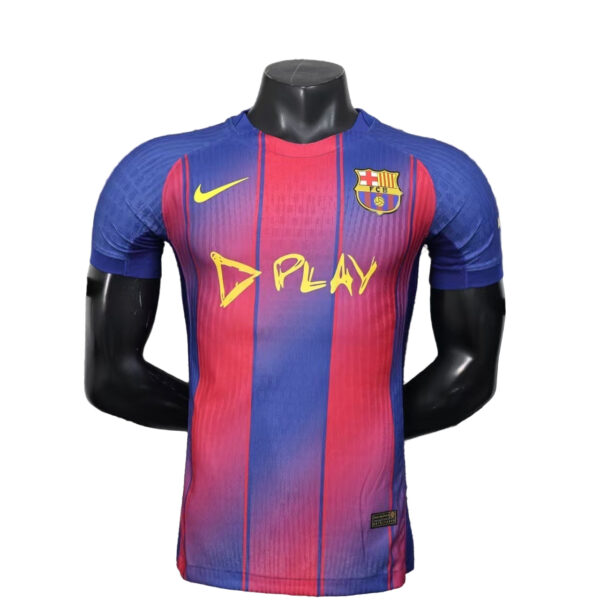 Red and blue Barcelona-style soccer jersey on a mannequin, with a yellow Nike swoosh and the FC Barcelona crest, featuring bold 'D PLAY' text across the chest.