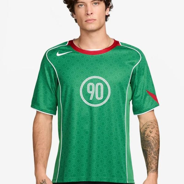 Male model wearing a green soccer jersey with white piping and the number 90 on the chest.