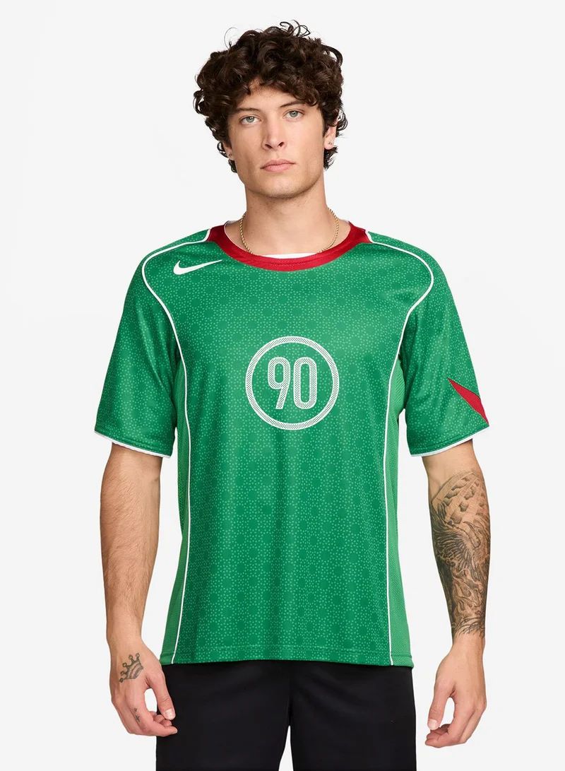 dfcbaa10-b1f7-45ec-859e-17a568f0e836 | UAE SPORT STORE Male model wearing a green soccer jersey with white piping and the number 90 on the chest.