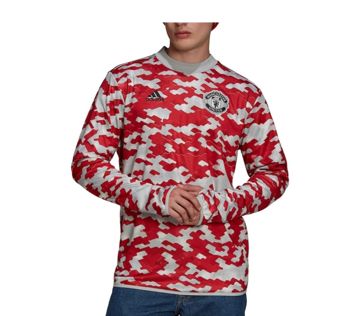 Man wearing a red and white camouflage Manchester United long-sleeve jersey with Adidas logo and club crest on chest.