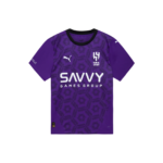 Purple football jersey with black collar and geometric hex pattern, featuring the white 'SAVVY GAMES GROUP' sponsor across the chest and the ALHILAL crest with Puma branding on the chest.