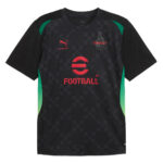 Black football jersey with red logo and geometric pattern, green side panels, and sponsor text 'FOOTBALL' on chest.