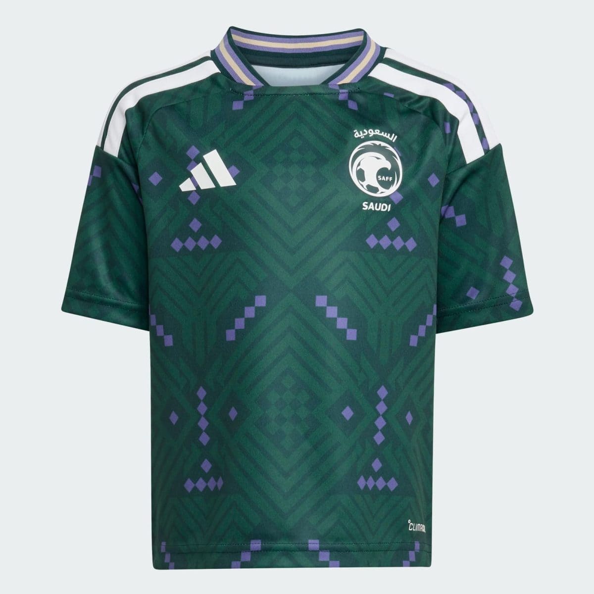 Green Saudi national team soccer jersey with geometric pattern, white Adidas logo, SAFF crest on the chest, purple accents, and white shoulder stripes.