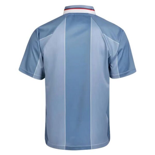 Back view of a light blue athletic polo with vertical darker blue panels and white seams, short sleeves, and a white-red-blue collar trim.