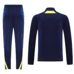 e19fe1a6 | UAE SPORT STORE Navy blue athletic tracksuit with a matching jacket and pants; yellow accents on the jacket neck and on the pant legs.