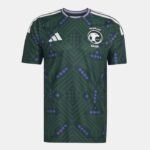Dark green Saudi Arabia football jersey with purple geometric pattern, white Adidas logo on the chest, and the national team crest on the other side. White shoulder stripes visible.