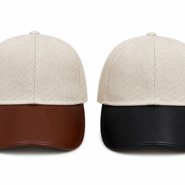 Pair of beige textured caps with contrasting brims—brown on the left, black on the right.