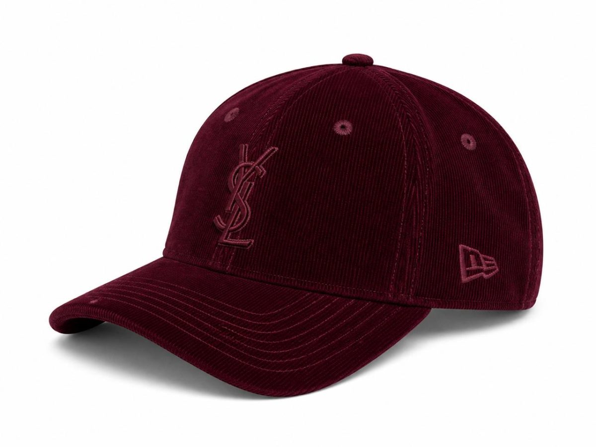 Burgundy corduroy baseball cap with a stitched YSL logo on the front and a New Era emblem on the side, curved brim facing left.
