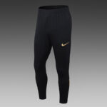 Black Nike athletic joggers with elastic waistband and a gold swoosh on the left thigh.