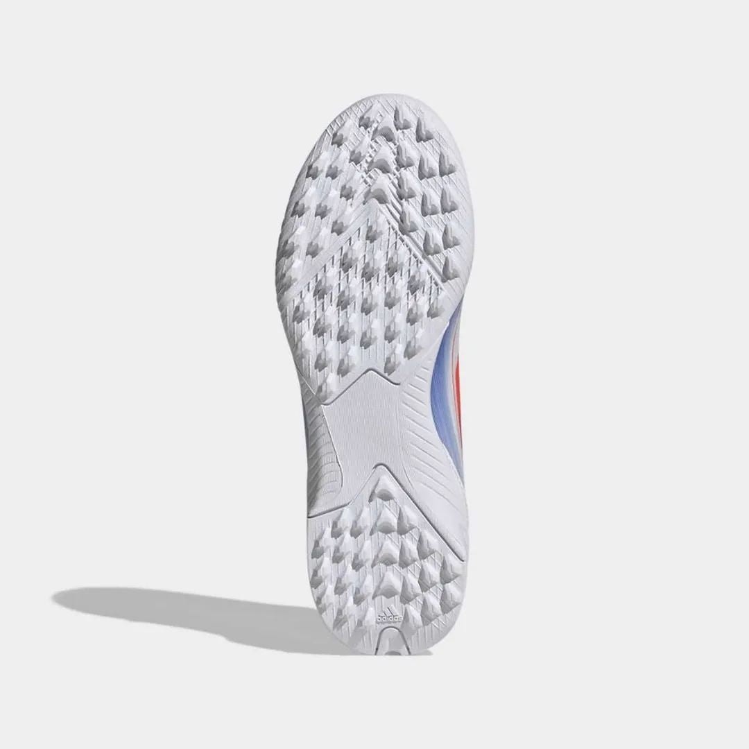 e2d5f245-9a0c-4669-93d1-19ff2d89a14b | UAE SPORT STORE Bottom view of a white Adidas running shoe outsole with textured tread pattern and side blue and red accents; small Adidas logo near the heel.