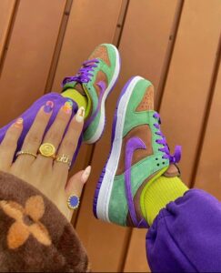 e31be6e7-eb5f-4699-8602-13685e261983_72acd74e-4ebe-49ec-b5f1-e37ecfc22338 | UAE SPORT STORE Colorful sneakers in green, purple, and brown with purple laces, worn with bright yellow socks and purple pants.