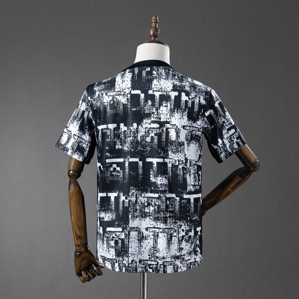Back view of a short-sleeve black-and-white abstract print T-shirt on a dress form, displayed mannequin style.