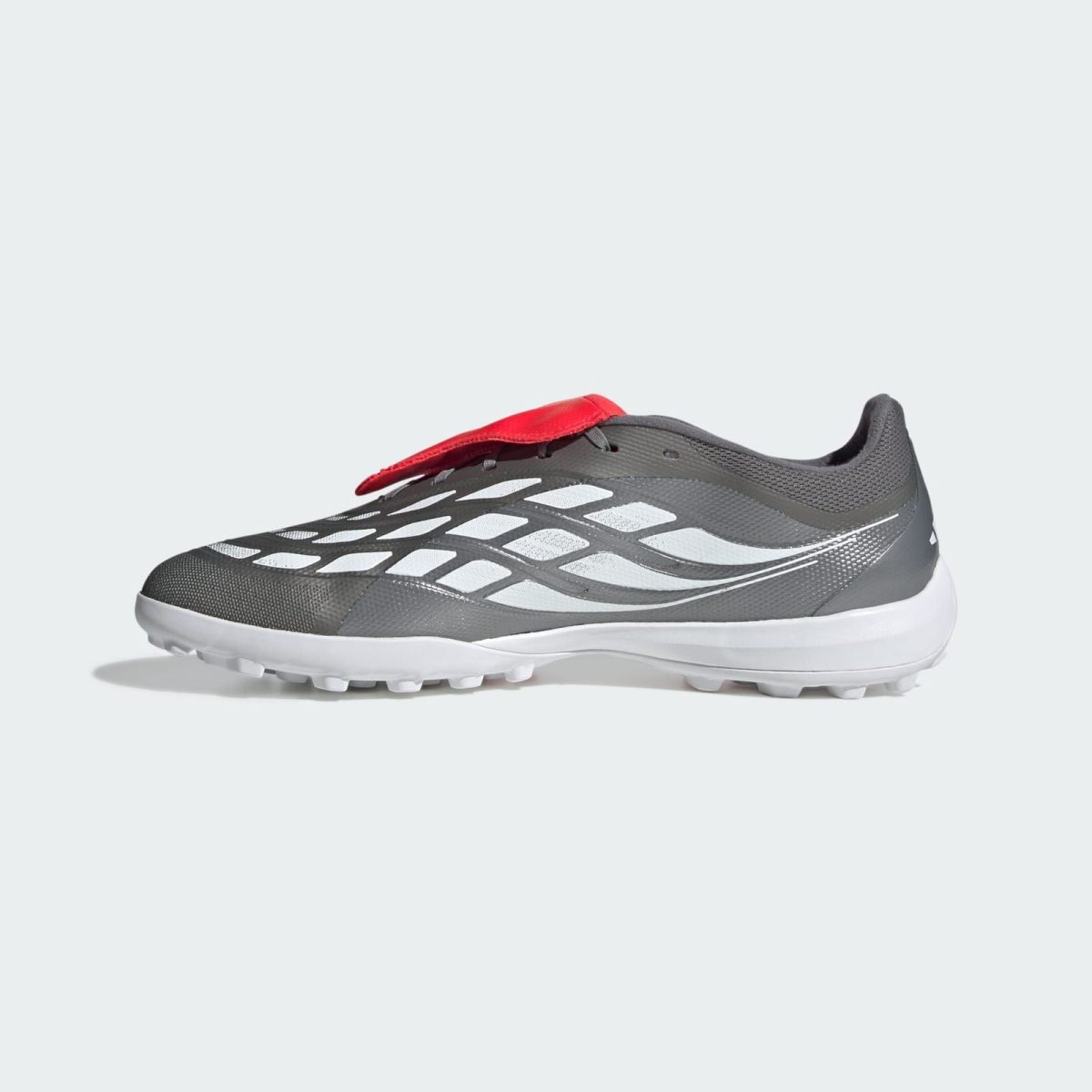 Grey and white athletic running shoe with a red heel tab and textured upper, shown from a side angle on a light background.