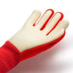 White rubber glove with a red fabric cuff on a white background.