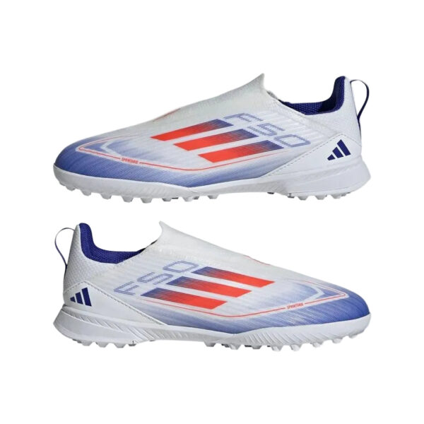 Pair of white turf soccer shoes with blue accents and red stripes, shown from side profiles against a plain background.