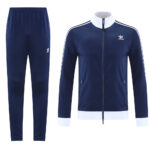Navy Adidas track suit with white cuffs and zip jacket, full-length pants shown separately