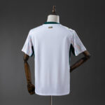 White short-sleeve jersey displayed from the back on a mannequin, with patterned sleeves and a small logo at the neck.