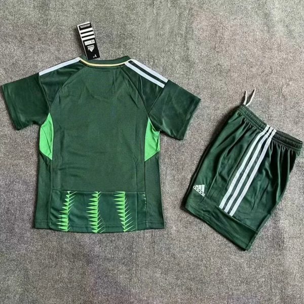 Green Adidas soccer jersey with lime-green side panels and matching shorts laid flat on a gray surface.