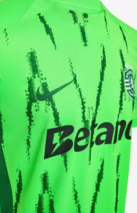 e6OKmyMp0FWQte5 | UAE SPORT STORE Close-up of a bright neon green soccer jersey with black brushstroke patterns, featuring a Nike swoosh and a team crest with the Betano sponsor.