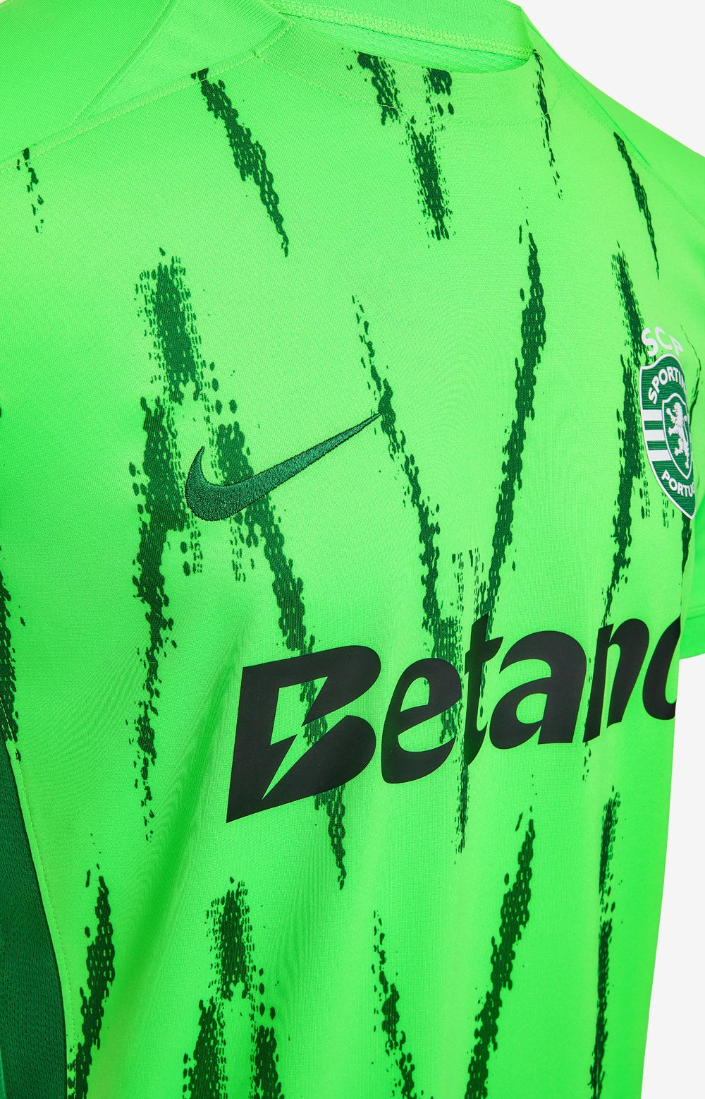 e6OKmyMp0FWQte5 | UAE SPORT STORE Close-up of a bright neon green soccer jersey with black brushstroke patterns, featuring a Nike swoosh and a team crest with the Betano sponsor.