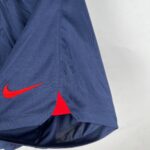 e6a09b16_712b40b0-36fe-44e1-9794-aad28f581be8 | UAE SPORT STORE Close-up of dark blue fabric with a red Nike swoosh logo visible near a seam.