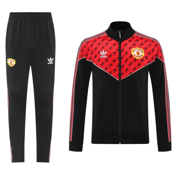 Manchester United Adidas tracksuit: black zip-up jacket with red chevron pattern and crest, paired with black pants with logo.