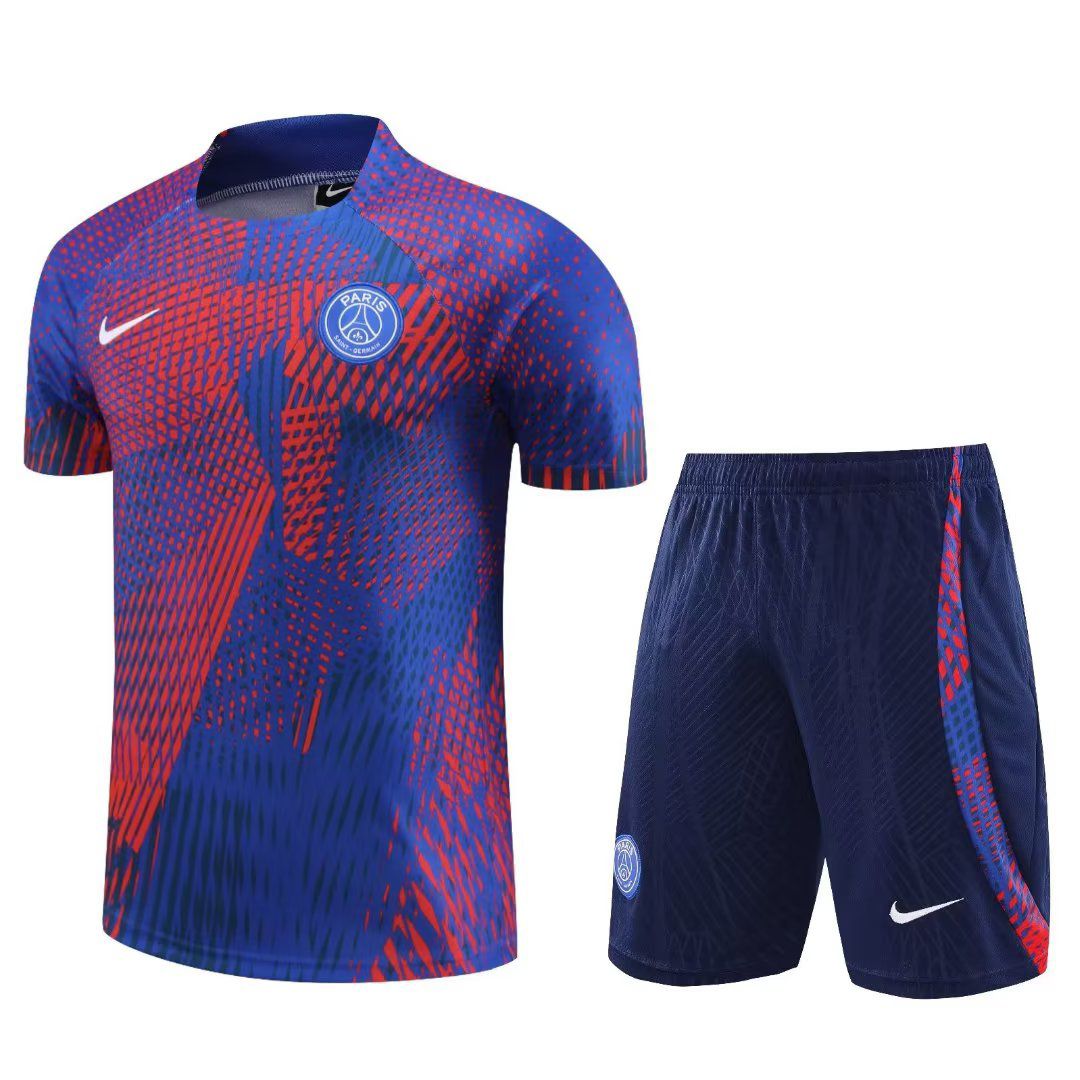 e806e5c6-cae7-4047-82d8-74d177747e3a_1046fdcb-d104-4447-b366-1d6f09794c4c Paris Saint-Germain football jersey and matching shorts in blue with a red geometric pattern, featuring the PSG crest and a white Nike swoosh.