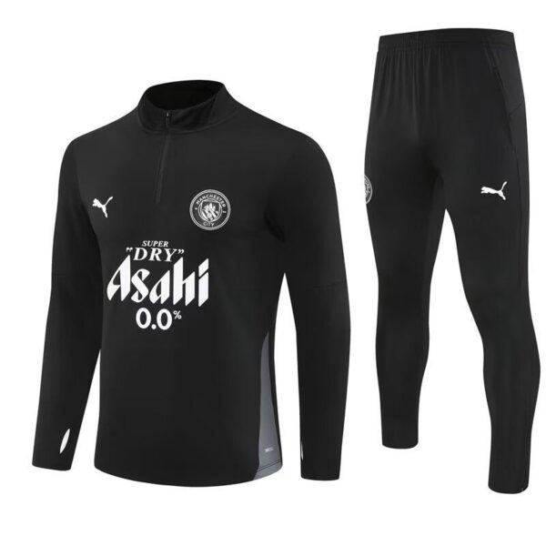 Black long-sleeve training top with quarter-zip and matching black pants; features white sponsor text 'Asahi 0.0%', Puma logos, and a circular team crest on the chest.