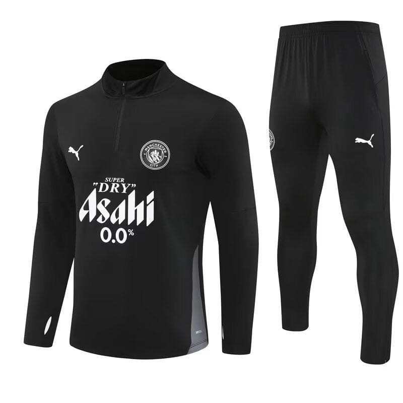 e85e56a7-49db-4e91-9154-8c7d080e2067 | UAE SPORT STORE Black long-sleeve training top with quarter-zip and matching black pants; features white sponsor text 'Asahi 0.0%', Puma logos, and a circular team crest on the chest.