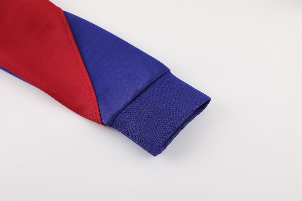 Close-up of red and royal blue folded fabric on a white background, highlighting the color contrast and textures.