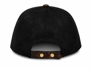 Back view of a black Louis Vuitton cap with an adjustable brown leather strap and gold studs, showing the monogram pattern