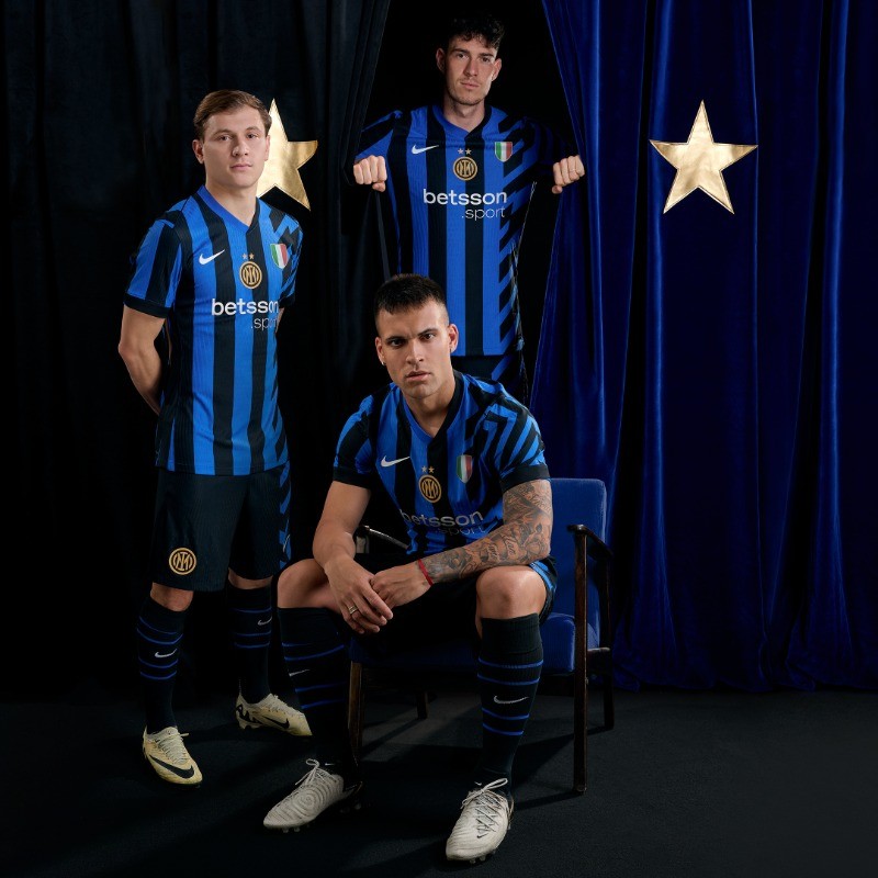 eFg451LMnIwOa8m | UAE SPORT STORE Three soccer players in blue-and-black striped Inter Milan jerseys posing for a backstage photoshoot against dark blue curtains with gold stars.