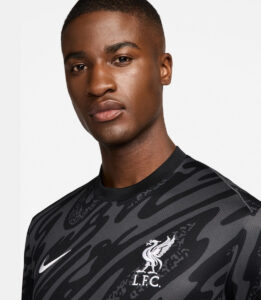 eRqVoQjeaxVz5Gz_2 | UAE SPORT STORE Close-up of a man wearing a black and grey camouflage Liverpool FC training jersey with Nike swoosh and LFC crest on the chest.