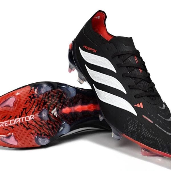 Black Adidas Predator soccer cleats with white stripes and red accents; studded outsole shown from-side angle, suitable for football.